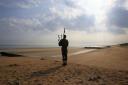 A bagpiper on Sword beach at Normandy, France. Picture: Jonathan Brady/PA Wire