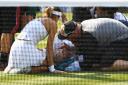 Bethanie Mattek-Sands of The United States receives treatment from the medical team and later retires from the Ladies Singles second round match against Sorana Cirstea of Romania on day four of the Wimbledon Lawn Tennis Championship