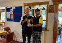 Dion Wood being presented with his trophy by captain Martin Catt