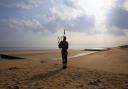A bagpiper on Sword beach at Normandy, France. Picture: Jonathan Brady/PA Wire