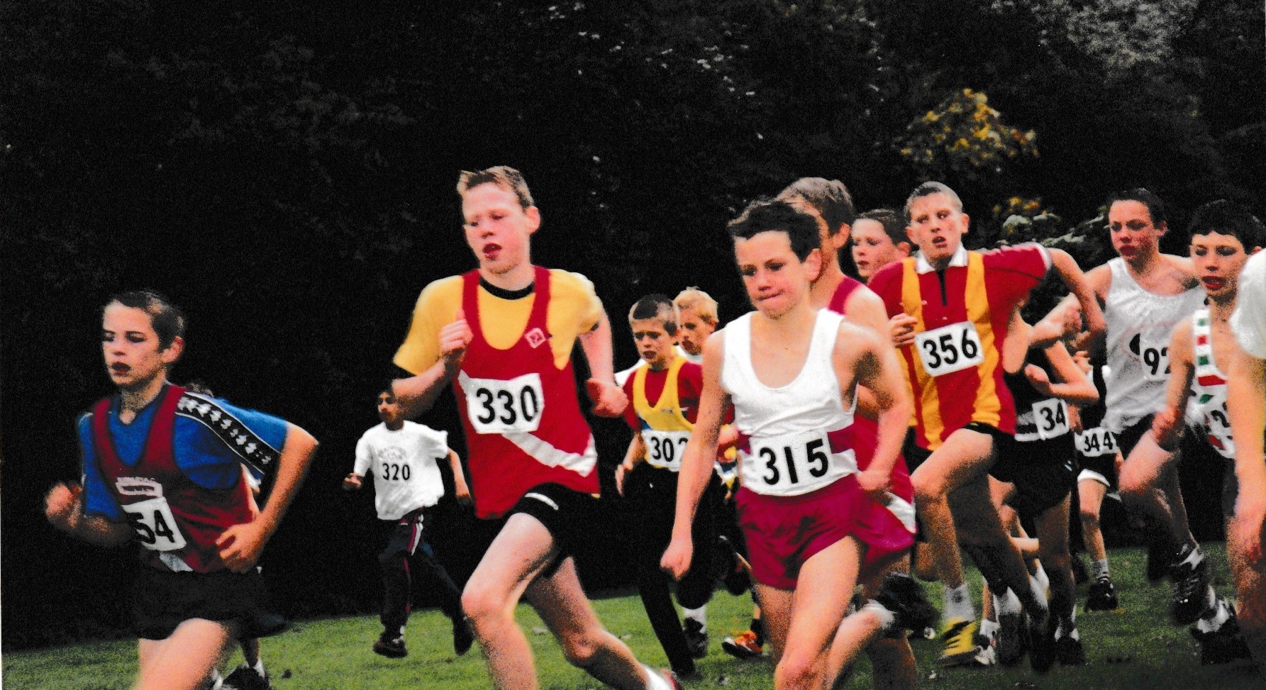 A young Richmond and Zetland athlete, in the red vest with a white stripe, running shoulder to shoulder with a young Alistair Brownlee on his journey to Olympic triathlon gold