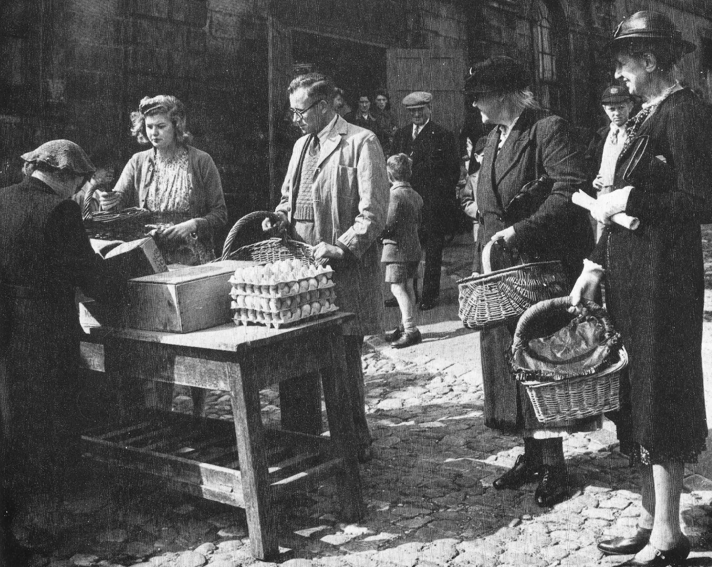 Saturday market outside the town hall in Richmond in 1945, with people queuing at the egg stall with their wicker baskets