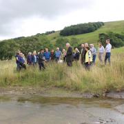 Rishi Sunak meets farmers and residents who have taken part in the Bishopdale natural flood management project by one of the scrapes (temporary ponds) created during the work