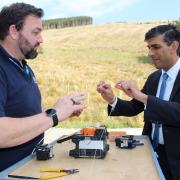 Rishi Sunak about to splice the fibre optic cable to activate the Cotterdale network with B4RN Communications Team Leader Steve Cottam