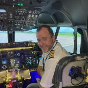 Welcome aboard...Stu Ellerton, in the cockpIt of the Boeing 737-800. Picture: Peter Barron