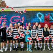 Darlington U12 Feethams girls football team infront of the Lioness mural at the Arthur Wharton Foundation in Darlington.