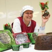 TRADITIONAL: Production assistant,Rachel Kraven shows off the range of plum puddings at Lewis & Cooper