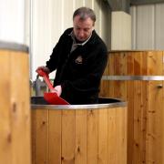 SPADE WORK: David Wall shovelling hops in the beer brewing vats
