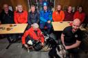 Handlers Mike Needham, foreground, and Tim Cain, with (left to right): Ian Wharton, Ron Allan, Deb Southwell, Alan Hinkes, Austen Floyd, Sam De Belle, and Helen Cain – relaxing at The George and Dragon, in Hudswell