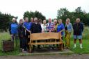 The volunteers hand over the bench at Catterick Golf Club