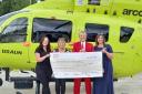 Peter presents the cheque to the Yorkshire Air Ambulance, with from left, Michelle Raine, YAA fundraiser, Barbara Fall, and Emma Robinson of Barclays