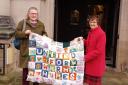 The CASaV United for Warm Homes quilt presentation, with left, Bridget Holmstrom, CASaV steering group member, and right, Yvonne Peacock, chair of North Yorkshire Council parliamentary constituency councillors’ group