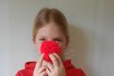 Laura Oosthuizen makes red pom poms to raise money for Comic Relief
