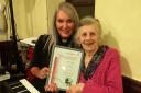 Elaine is presented with her certificate by Rev Melanie Reed