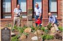 The Rotary Garden with, from left to right, President Chris Johnson, Council Leader Mark Robson, and President Malcolm Warne, with a close-up of the Rotary plaque, inset