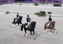 Great Britain s Carl Hester (centre), Charlotte Fry (left) and Charlotte Dujardin (right) celebrate with their Bronze Medals during the Dressage Team Grand Prix Special at the Equestrian Park on the fourth day of the Tokyo 2020 Olympic Games in Japan