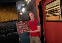 Volunteer Marc Davies with signs of the cinema's history as well as the newly installed downstairs seating Picture: RICHARD JEMISON