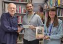 John Elm, left, presents a cheque for £200 to Adam Hartley, shop manager and Lou Caunt, volunteer