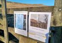 Objectors have posted signs close to the site of the proposed mast, with Whernside behind