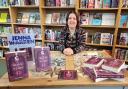 Jenna Warren at Guisborough Bookshop with copies of her debut novel