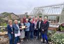 Dee Venner, county officer for the National Garden Scheme, presents a plaque to volunteers and supporters at Bellerby