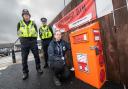 North Yorkshire Council community safety officer, Evie Griffiths, with North Yorkshire Police officers, PCs Kelvin Troughton and Brendon Frith, at the knife drop bin in Harrogate