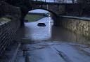 A vehicle in floods on a road at Romanby, near Northallerton