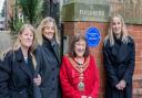Cllr Jan Cossins and members of the Bradshaw family, Kate, Sam and Viveca, and the plaque dedicated to Clara Lucas