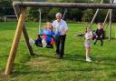 Councillor Steve Kay with (left to right) grandchildren Emily, Penelope and Thomas on the playing field at Charltons