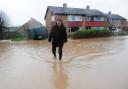 FEET FIRST: Stewart Barber walks through flood water near his home in Northallerton during the latest floods