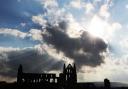 Rays of sunlight shine through Whitby Abbey – but do its bells still sometimes toll out at sea?