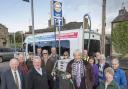 : Cllr John Blackie (centre) at the Hawes filling station with Cllr Carl Les, (far left), North Yorkshire’s Leader, volunteer drivers of the Little White Bus and Upper Dales residents