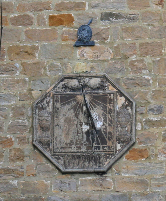 The sundial and, top, the Phoenix firemark above the door of Silvio House in Richmond