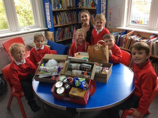 The Trinity Group from Marwood Primary with Isla Medd's mother Kate and some of the gift boxes