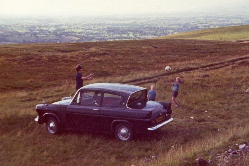 Brian Wastell and his family with his first car, a Ford Anglia, photographed just off the B6270 beyond Ravenseat as it begins to drop into Nateby and then Kirkby Stephen. Brian bought the Anglia - registration 3924HN - for £90 in March 1970 from