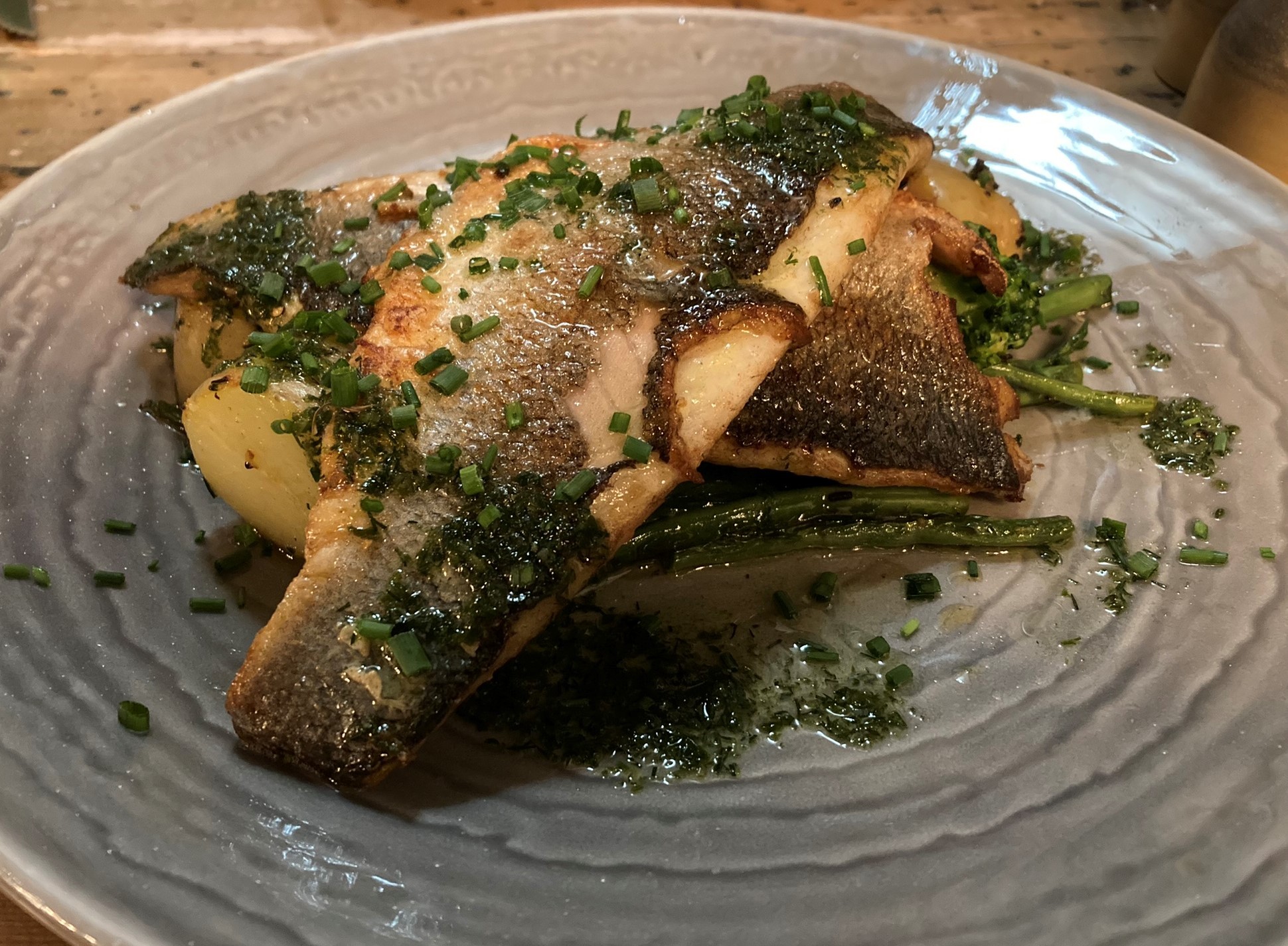 The pan-fried sea bass on a bed of greens