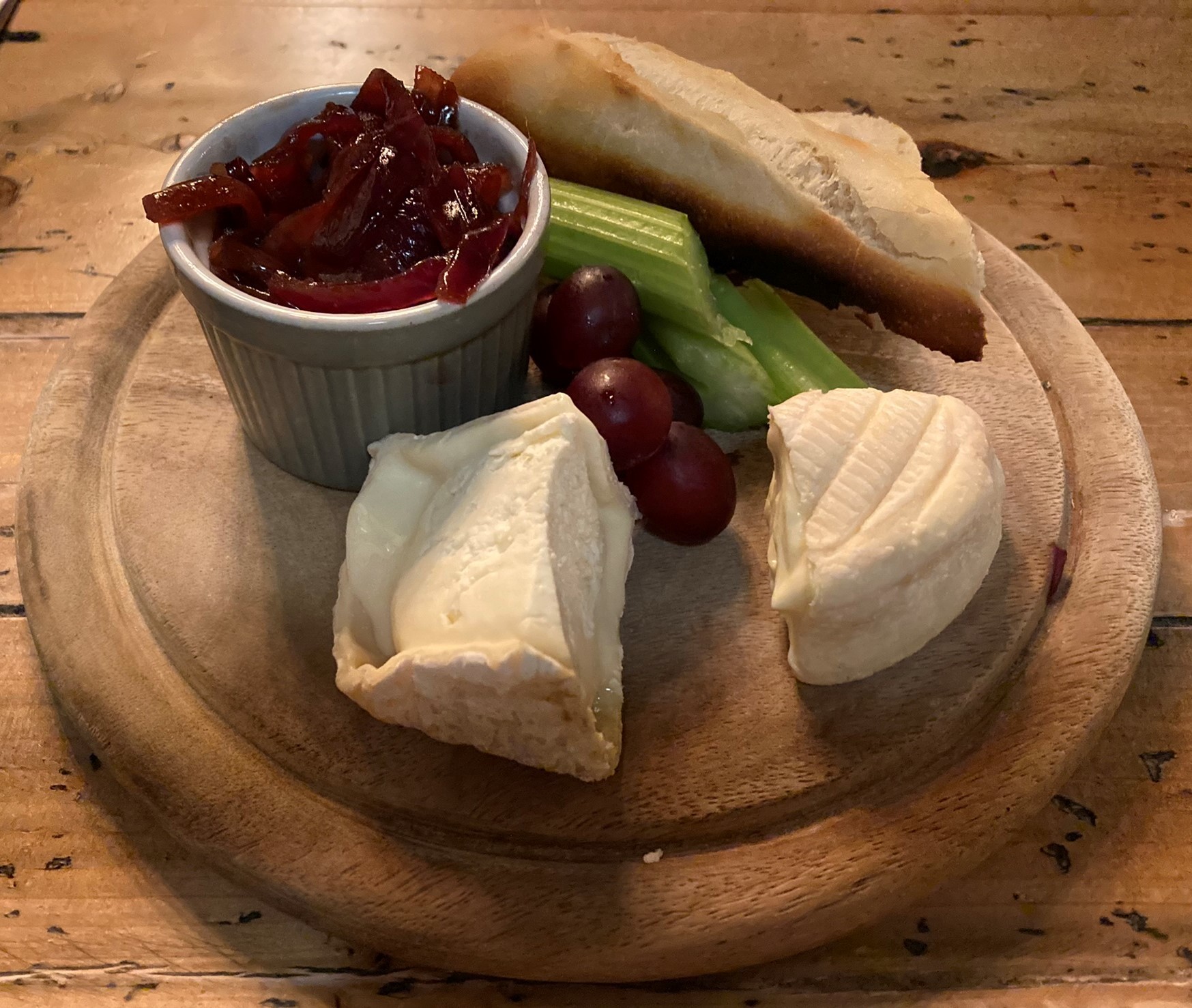 Two goey French cheeses on the cheeseboard