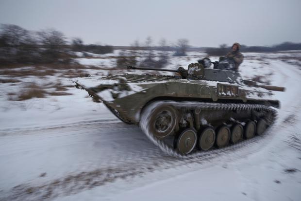 Ukrainians drive an armoured personnel carrier near a frontline position in the Luhansk area