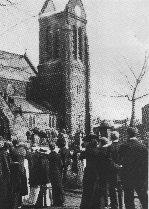 The congregation watches as ladders are placed against the tower of St Marks Church, Marske-by-the-Sea