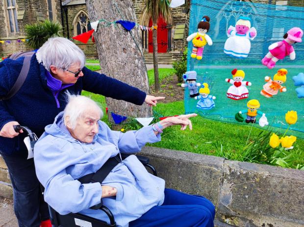 Darlington and Stockton Times: Hazelgrove Court Care Home volunteer Lynn Walshaw with resident Joyce Baxtrem, 90, at the knitted display at Emmanuel Church