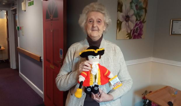 Darlington and Stockton Times: Hazelgrove Court Care Home resident Joyce Tibbett, 88, with one of the dolls she helped created for the display at Emmanuel Church
