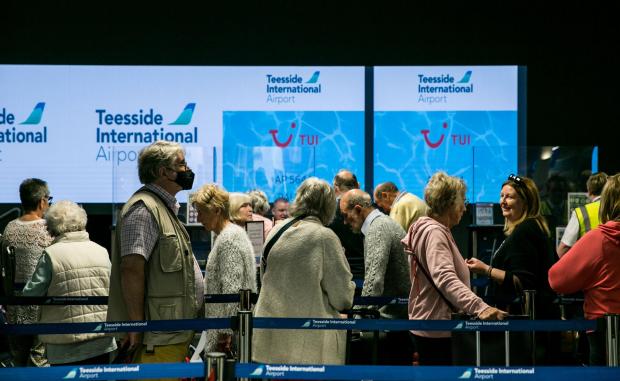Darlington and Stockton Times: Passengers queue ahead of their flight on Tuesday. Picture: SARAH CALDECOTT