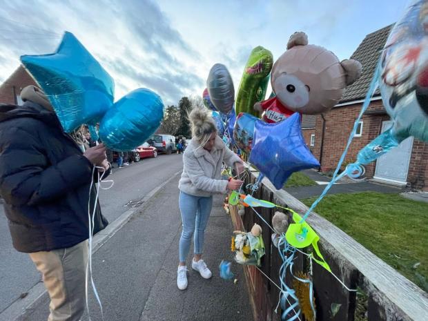 Darlington and Stockton Times: Well-wishers place balloons, toys and candles, in tribute to the youngster. Picture: SARAH CALDECOTT