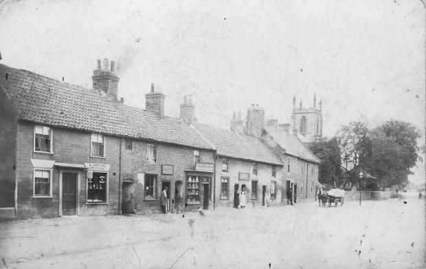 Darlington and Stockton Times: The east end of Hurworth: the two buildings on the right have been demolished to enlarge the churchyard. The building in the centre with the large shop window is now the fish and chip shop on the end of the row