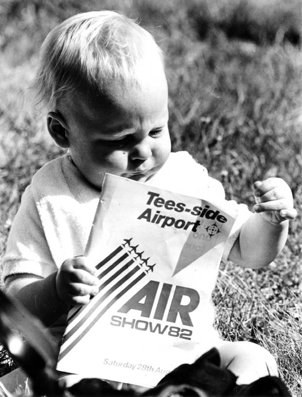 Darlington and Stockton Times: Young Martin Sanderson of Guisborough enjoys flicking through the programme for the 1982 air show that was held at "Tees-side Airport"