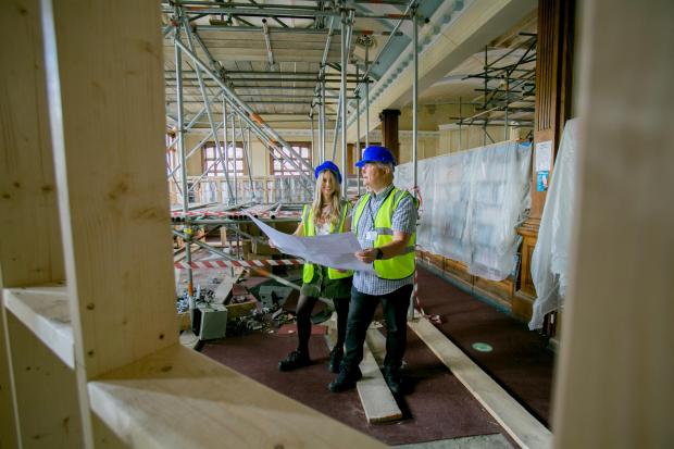 Darlington and Stockton Times: Darlington Library Manager Suzy Hill and Cllr Andy Keir inside the renovation of Darlington Library Picture: SARAH CALDECOTT