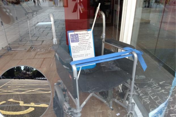 The wheelchair and white cane in the window at the Streetlife centre in Coney Street as part of a call for a ban on Blue Badge parking in footstreets to be reversed