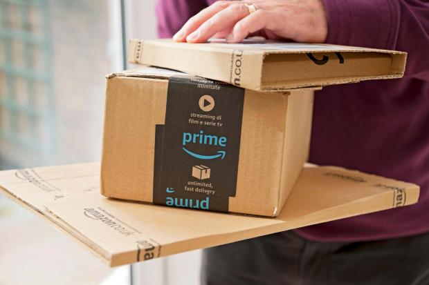 Darlington and Stockton Times: A person holding Amazon Prime packages