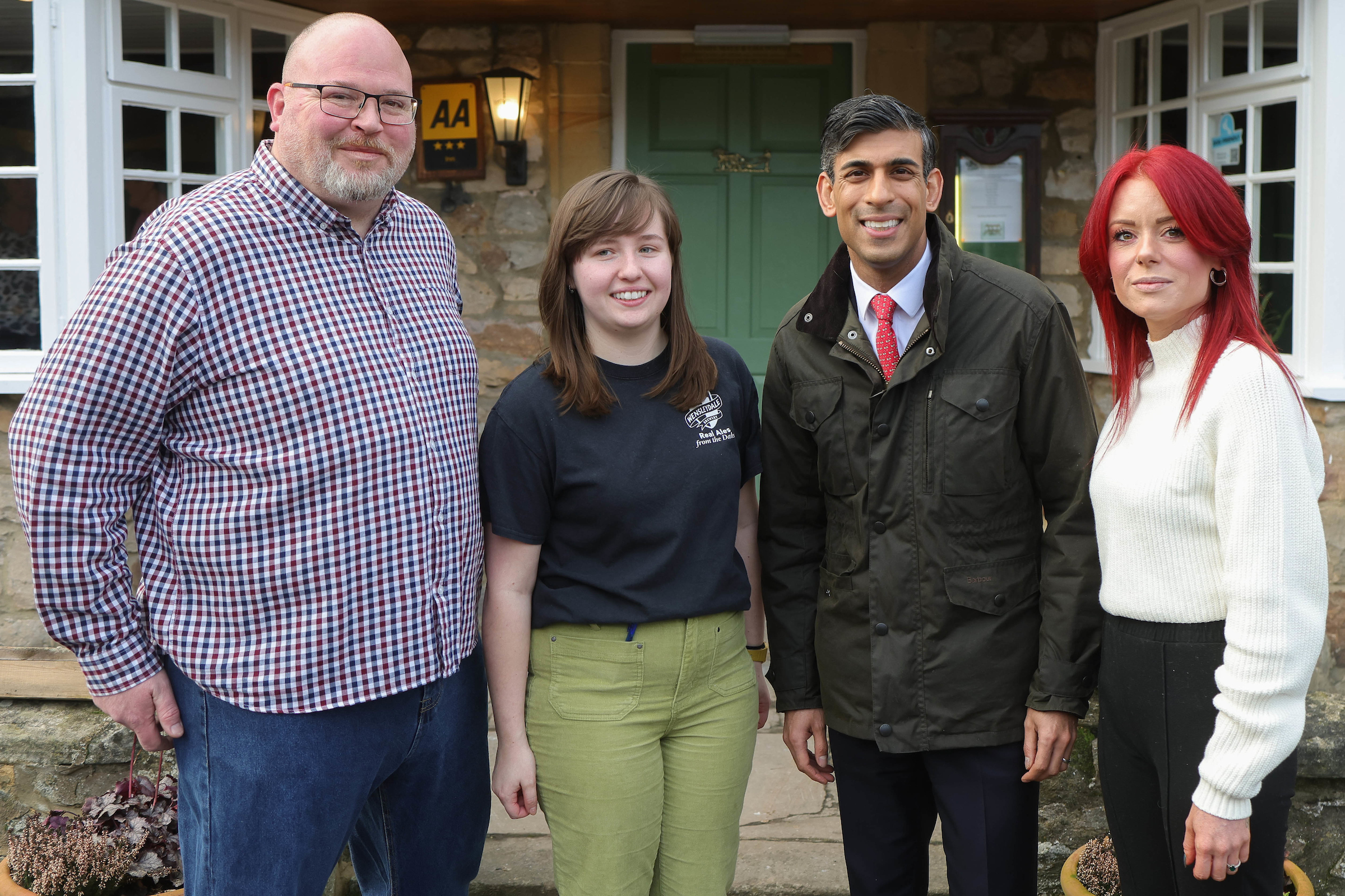 Rishi Sunak with tenants Dan Male, left, and Lisa Lowry with part-time staff member Charlotte Heap, centre
