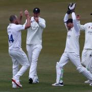Ben Raine celebrates after claiming a wicket for Durham